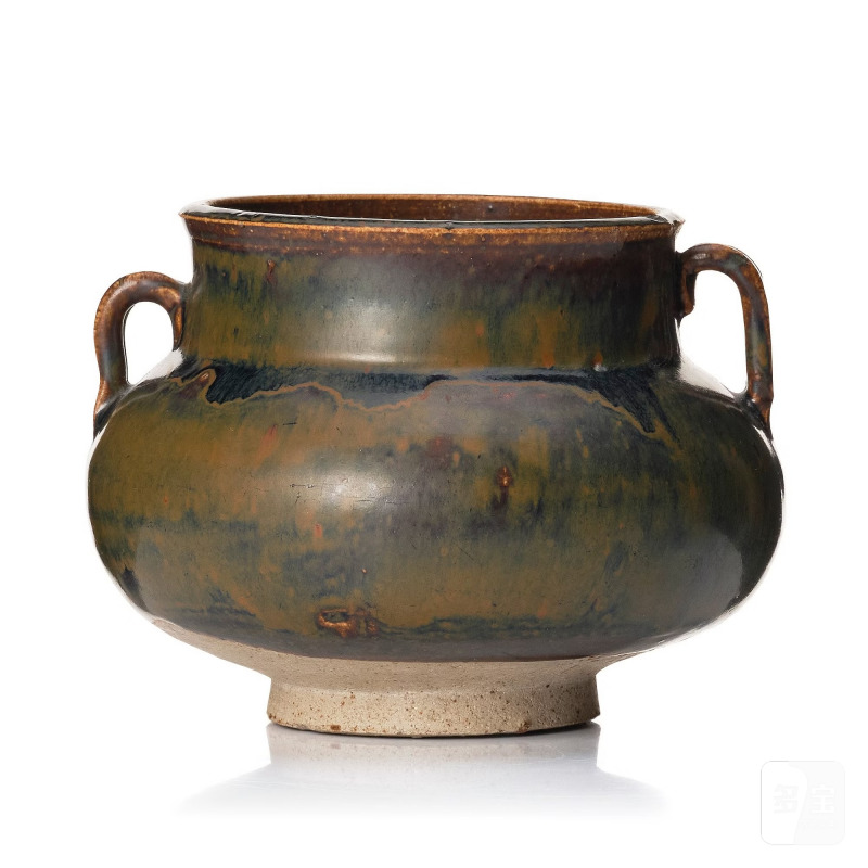 A black and brown glazed stoneware jar,